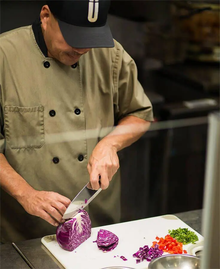Überrito chef preparing fresh ingredients for a catering order